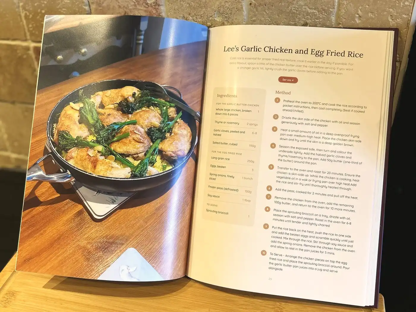 An open personalised cookbook showing a garlic chicken recipe beside a full-page photo of the finished pan