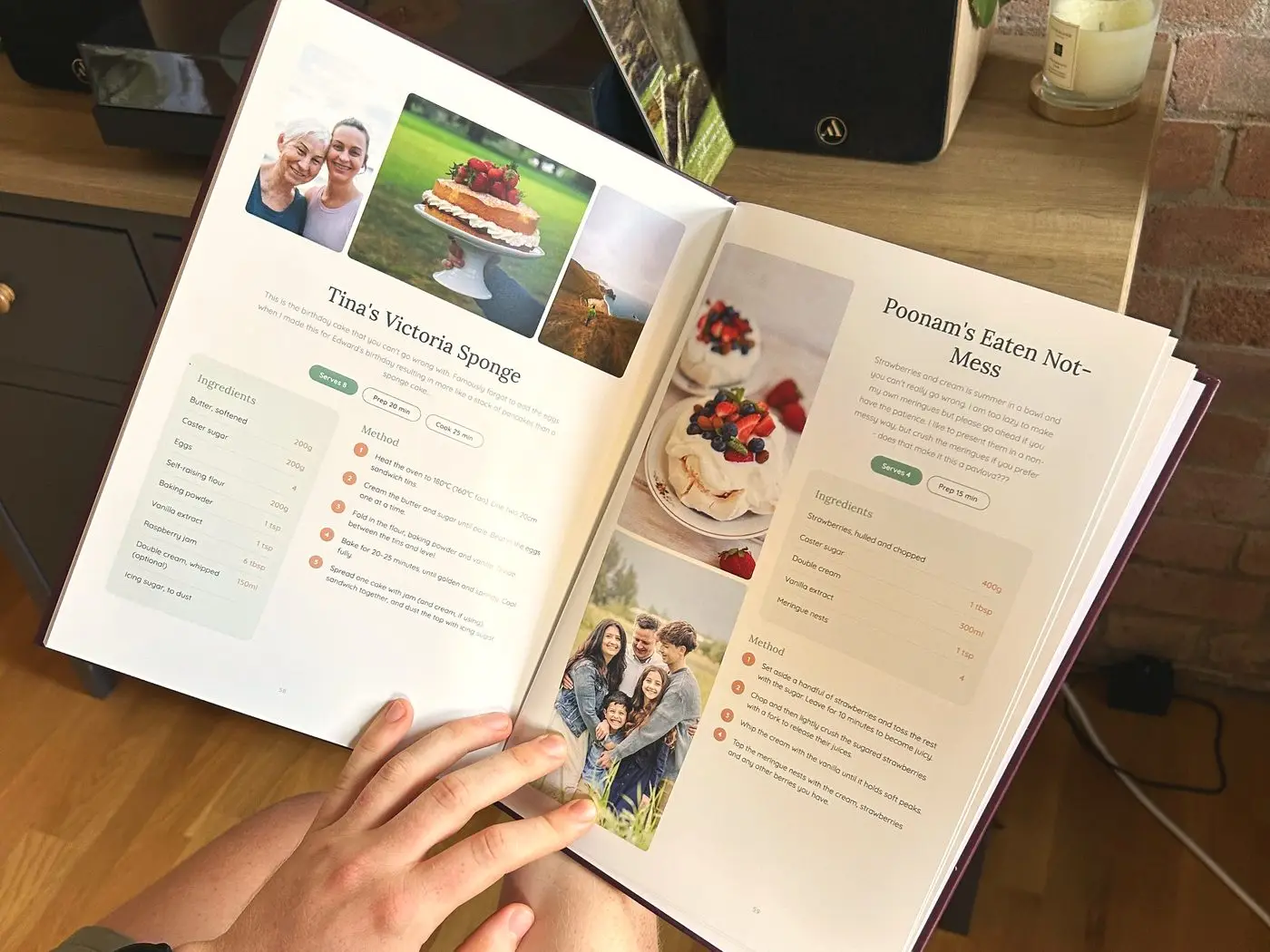 An open personalised cookbook showing a Victoria sponge recipe beside family photographs